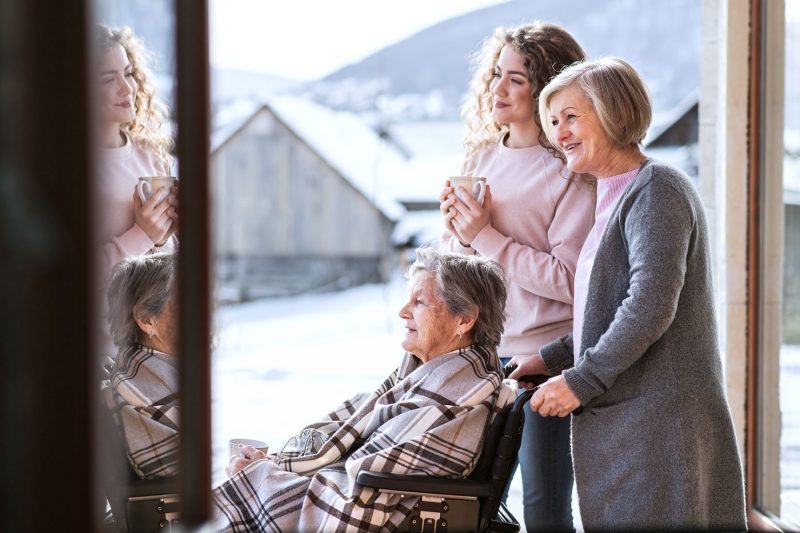 Guardianship & Conservatorship: Three generations of women look out a window.